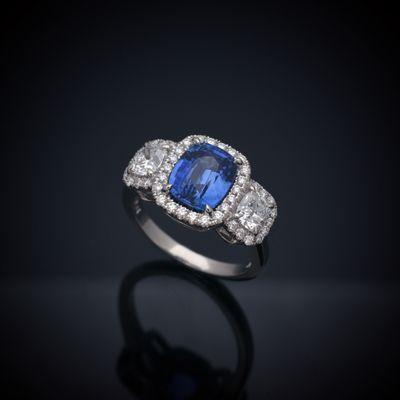 3.13 Carat GIA Certified Cushion Cut Unheated Sapphire in a Platinum Diamond Halo Ring with Cushion Cut Side Diamonds totaling .81 carat.