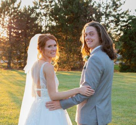 Wedding couple posing looking at camera.