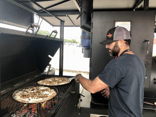 The Pitzza smoked over open fire of pecan wood