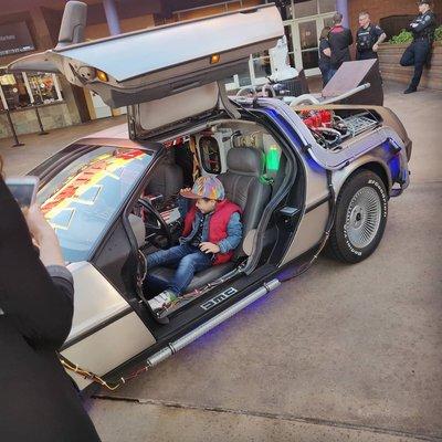 Fans enjoy sitting in the Delorean Time Machine