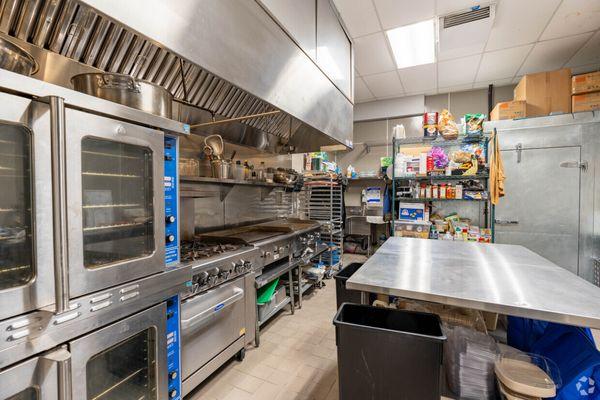 Private Commercial kitchen with ovens, stove, plancha and walk-ins.