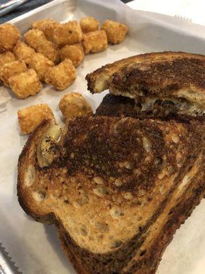 Delicious patty melt and tater tots.