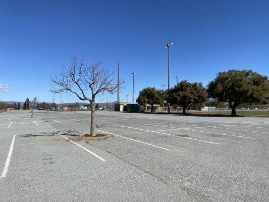 Parking lot with softball/baseball field in the distance.