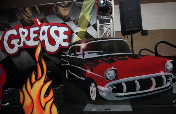 Grease themed backdrop and props