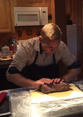 Rolling the roast in pastry.