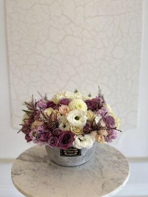 A mix of purples & whites in a vase