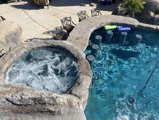 Spa and swim up bar, this hot tub is perfect for a at home getaway. With the swim up bar and built in setting why not make it a party?