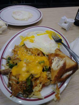 2 eggs over medium, hash browns with veggies & cheese sauce, toast.