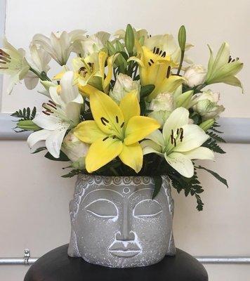 Buddha planter with yellow and white lilies