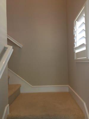 Stair wall crack/bulge in drywall  was repaired, textured and painted. Flawless results.