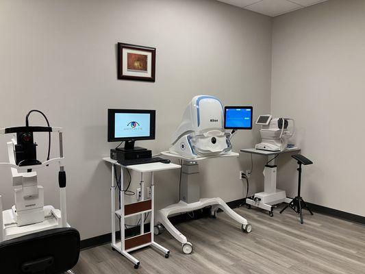 Our Diagnostic Testing room, featuring an OCT device, a Fundus Photo camera, and an Auto-Refractor.