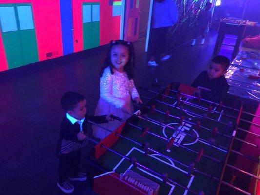 Kids playing foosball.