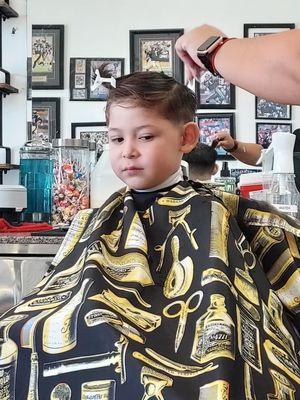 Five year old getting a cut for school.Happy.