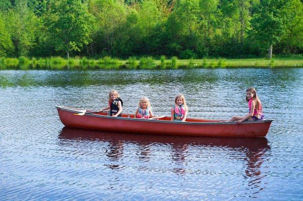 The girls checking out the pond in the row boats they had available by the ponds.