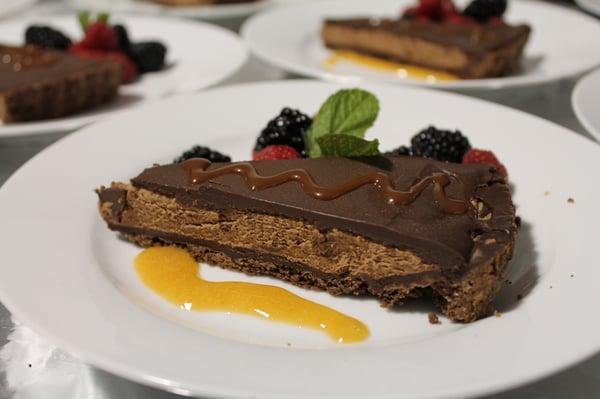 Chocolate musse tart with assorted summer berries and goat milk caramel