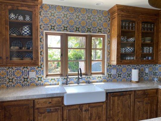 TAJ MAHAL kitchen countertops with a tile backsplash 

Professionally installed by the Serrano Team