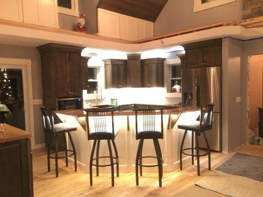 Custom kitchen cabinets, hardwood floor, and a solid hickory ceiling that turned out great.