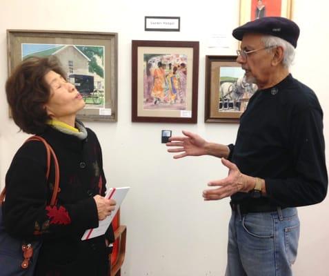 Artist Bukang Kim visits with Art Circle member Gurdev Mangat. ©Connie Springer