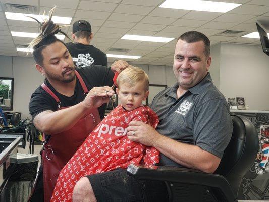 Chris giving our two year old his first hair cut.