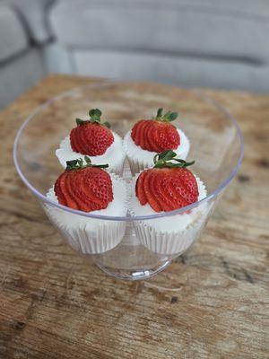 Vanilla angelfood cupcake with a toasted marshmallow icing and cut Strawberries