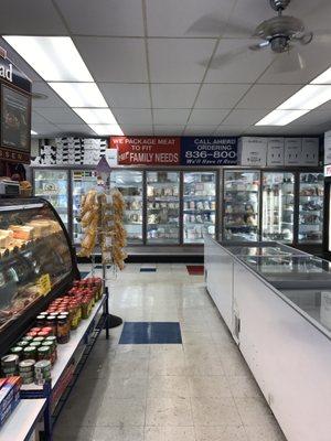 Shelving beneath each case displays helpful items you may need to accompany your meats. Back freezer includes fish plus much more.