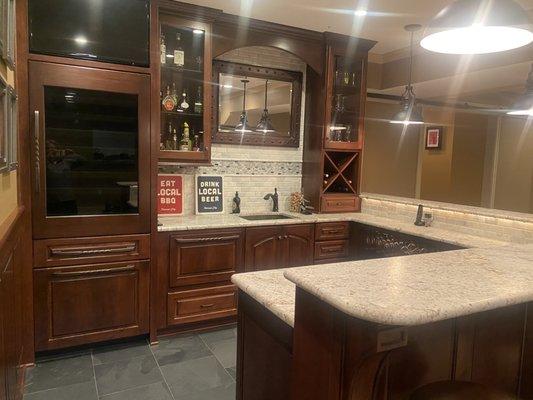 Bar with full size wine refrigerator, dish washer, ice maker, microwave and full size sink