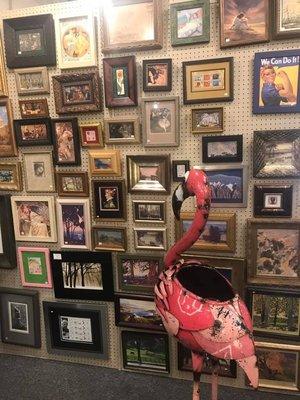 Aladdin's mascot, Florence the Flamingo admires the wall of mini art.