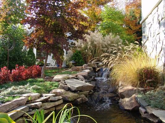 Full backyard makeover (plantings, water feature, pergola, turf, and more) in Fairfax, VA