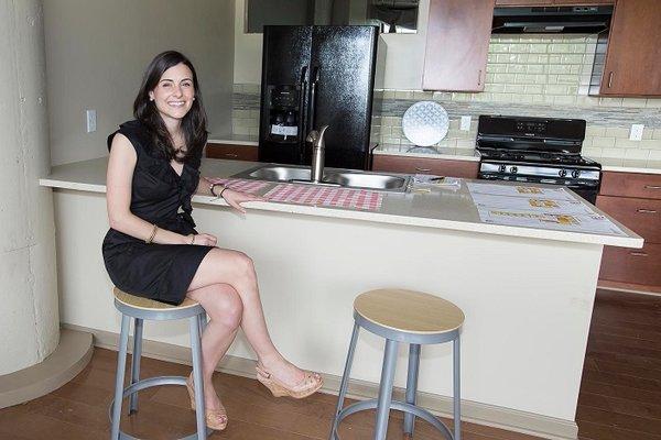 One of our real estate agents displaying a kitchen in an apartment in Buffalo, NY