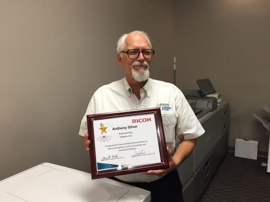 Here technician Tony Silver poses with his Prestige Award...only earned by 10% of the techs in the country that even attempt the test!