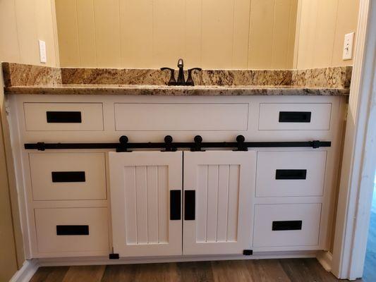 Custom vanity with barn doors.