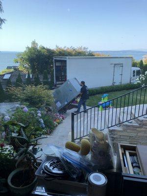 Taking the refrigerator down 15 steps to their truck! Such a hard job!