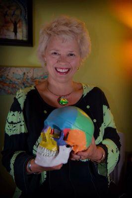 Deana with the skull model that helps with explanations of Craniosacral work.