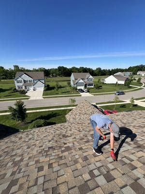 Marking lifted shingles from high winds during roof inspection