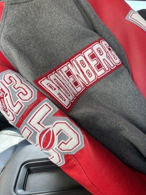 Letterman jacket with patches sewn on.