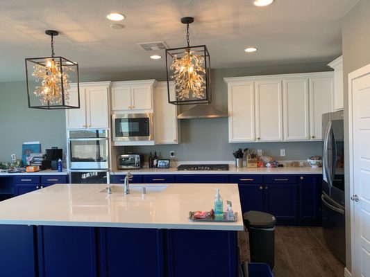 Blue lower and white upper cabinets.