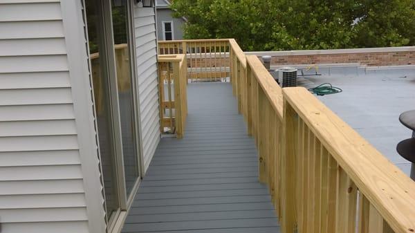 A rooftop deck Built in Wriglyville. The deck was built with Trex hidden fastener system and the color was pebble gray.