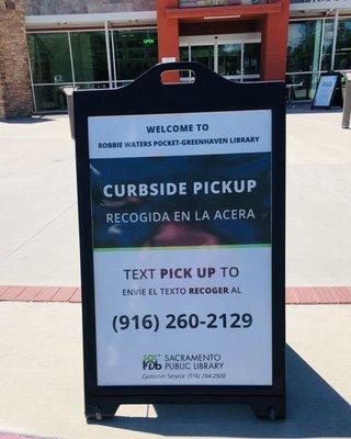 Curbside book pickup sidewalk sign