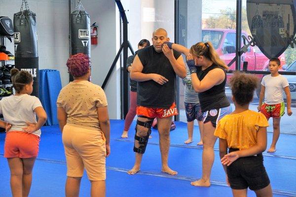 Our Muay Thai coach Javier instructing a kid's class