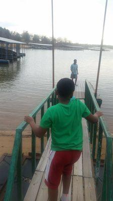 The kids walking on the dock at snug harbor cabin