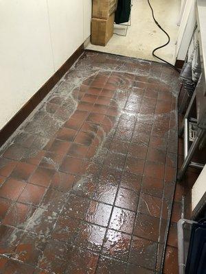 machine scrubbing kitchen floor