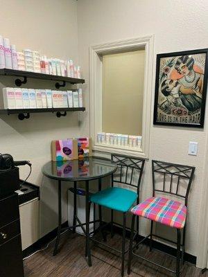 The chairs by the front door of my salon suite and shelves with product above them.