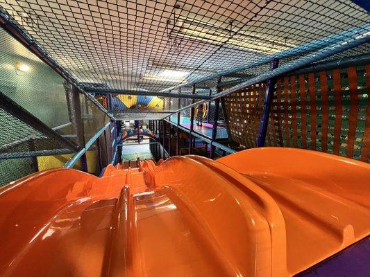 Top of the slide on the multi-layered playground. Easily accessible for adults if needing to follow a little one.