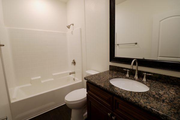 Luxurious Bathrooms with Granite Countertops, Beautiful Mirrors, Upgraded Cabinets and Plumbing Fixtures