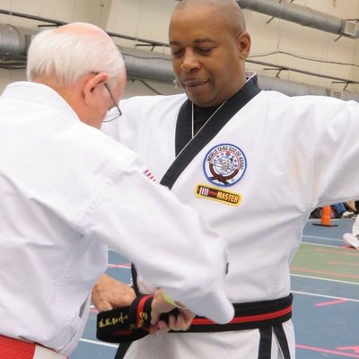 Brian Willis, Sr., Chief Instructor, receiving his Master's Belt from  Grandmaster Strong.