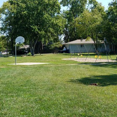 small basketball court and swings