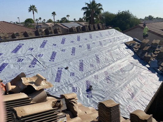 New titanium synthetic underlayment being applied to roof decking