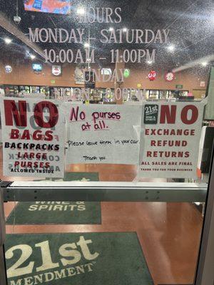 Store hours and sign saying no purses allowed