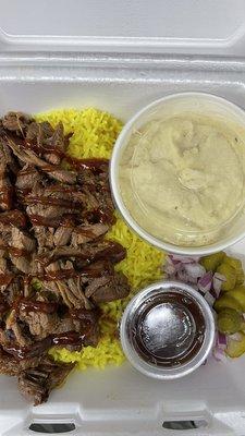 Yummy plate with smoked rice and u can choice any side with bbq sauce pickles and onions