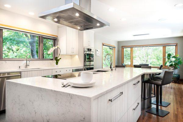 One of the more aesthetic innovations in contemporary kitchens today is the waterfall countertop (like this one we did for a happy customer!